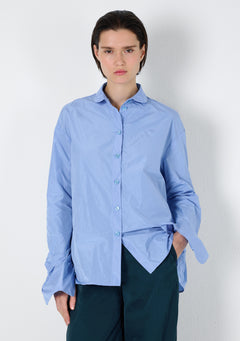 Hellblaue oversize Bluse, mit Bubi Kragen und abgerundeten, langen Manschetten in der Detaillansicht